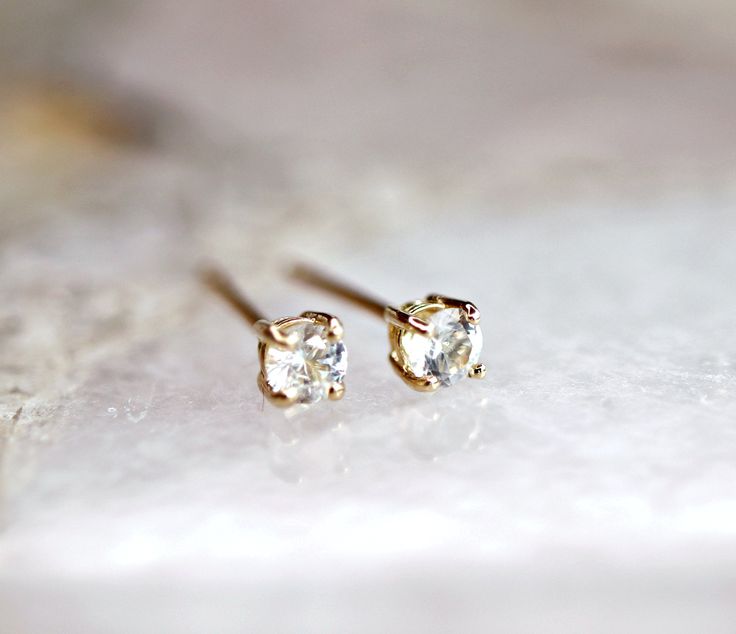 "14k yellow gold and white sapphire stud earrings. They will make a great companion to your beautiful wedding. They are very elegant for daily use or for official gatherings. SOLD AS PAIR. Available white gold or yellow gold from drop down menu. Material; 14k solid gold studs Round white sapphire 3mm Prong settings. 14k gold backings included. ------------------------------------ GIFT WRAPPING My regular package is organza gift pouches or small gift box for protection. If you would like special Delicate Single Diamond Earrings For Anniversary, Dainty Yellow Gold Diamond Earrings With Single Cut, Delicate Brilliant Cut Earrings For Gift, Minimalist Yellow Gold Diamond Earrings For Wedding, Delicate 14k Gold Diamond White Earrings, Delicate Diamond Earrings With Single Diamond For Gift, Delicate Diamond Earrings With Prong Setting, Dainty Diamond Earrings With Single Cut Diamonds For Wedding, Dainty Diamond Earrings With Single Cut For Wedding