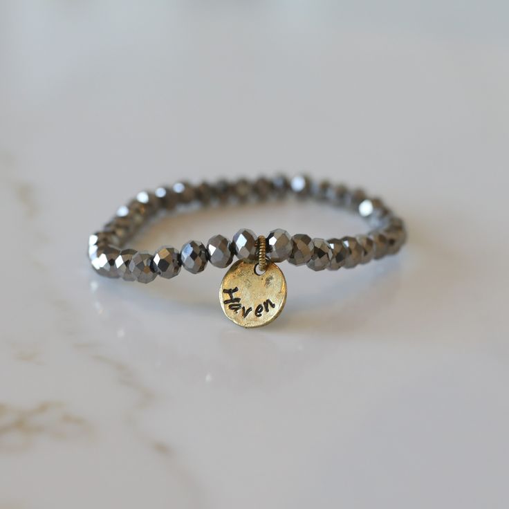 Add some bling to your wrist with our Personalized Crystal Stacks! You can personalize your stack bracelet with a name, date, initials, or a word of choice on a simple, classic disc charm. With neutral colors and faceted beads that shine and shimmer in the light, you can be reminded of a motivating word, memory, or special loved one whenever you look down at your wrist! A perfect gift for the everyday stack wearing lover! *Elastic stack bracelets are made with 6mm faceted crystals *Personalized Adjustable Nickel-free Name Bracelet For Everyday, Everyday Stackable Round Name Bracelet, Adjustable Round Name Bracelet For Everyday, Personalized Silver Beaded Bracelets For Everyday, Everyday Silver Stackable Name Bracelet, Silver Stackable Name Bracelet For Everyday, Silver Beaded Bracelet With Custom Name For Everyday, Customizable Silver Stretch Bracelet, Adjustable Silver Stretch Bracelet Customizable