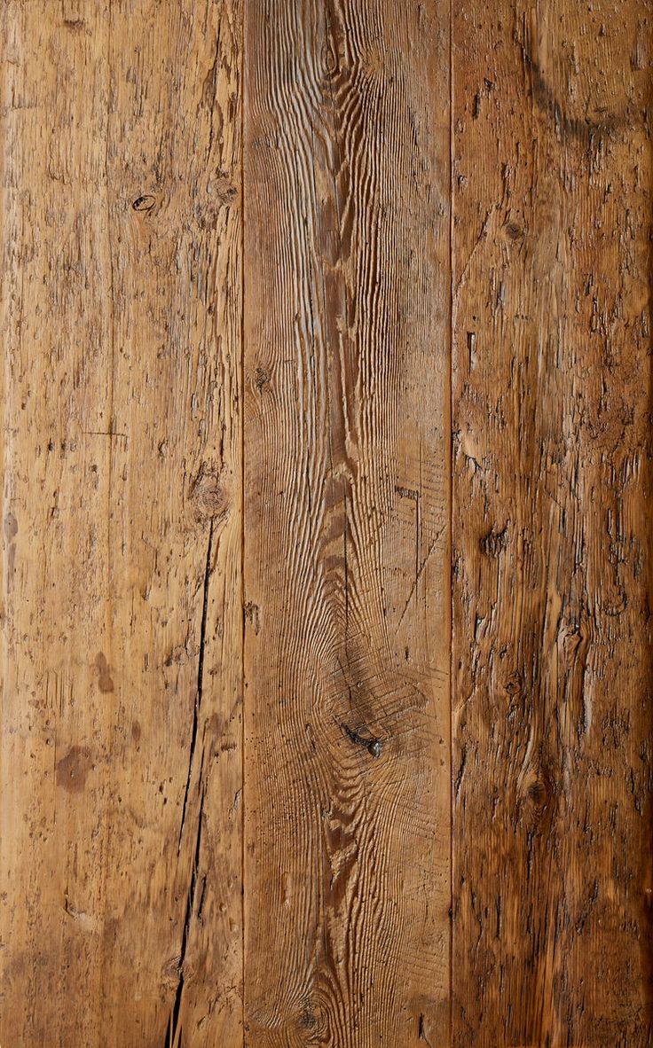 an old wooden wall with peeling paint and wood grains on the bottom half of it