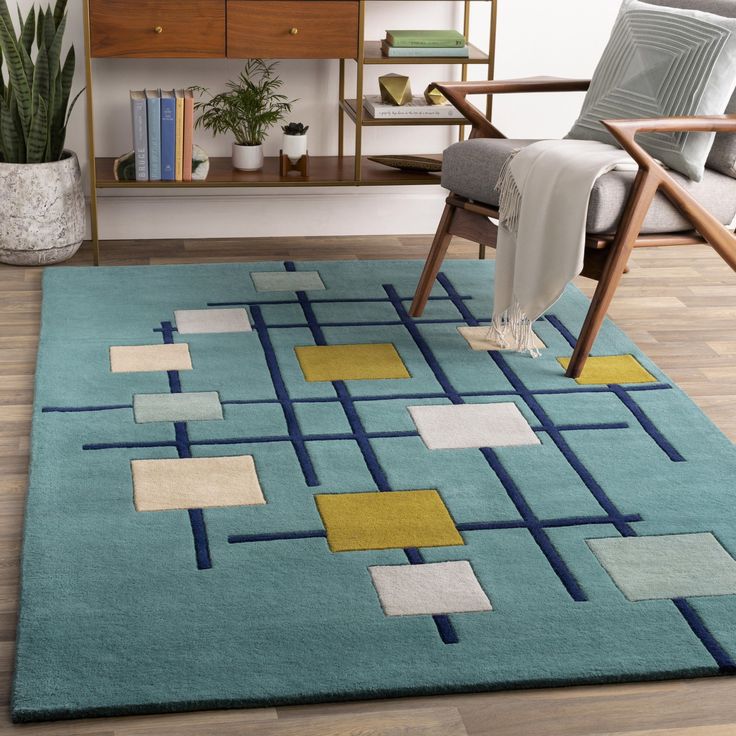 a blue rug with yellow and green squares on it in front of a wooden table