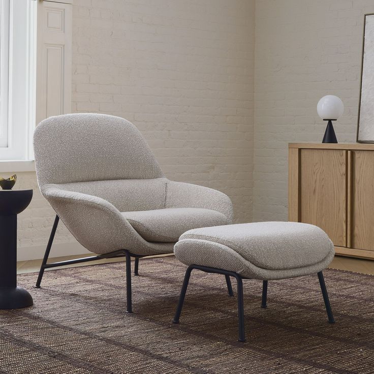 an egg chair and ottoman in a living room