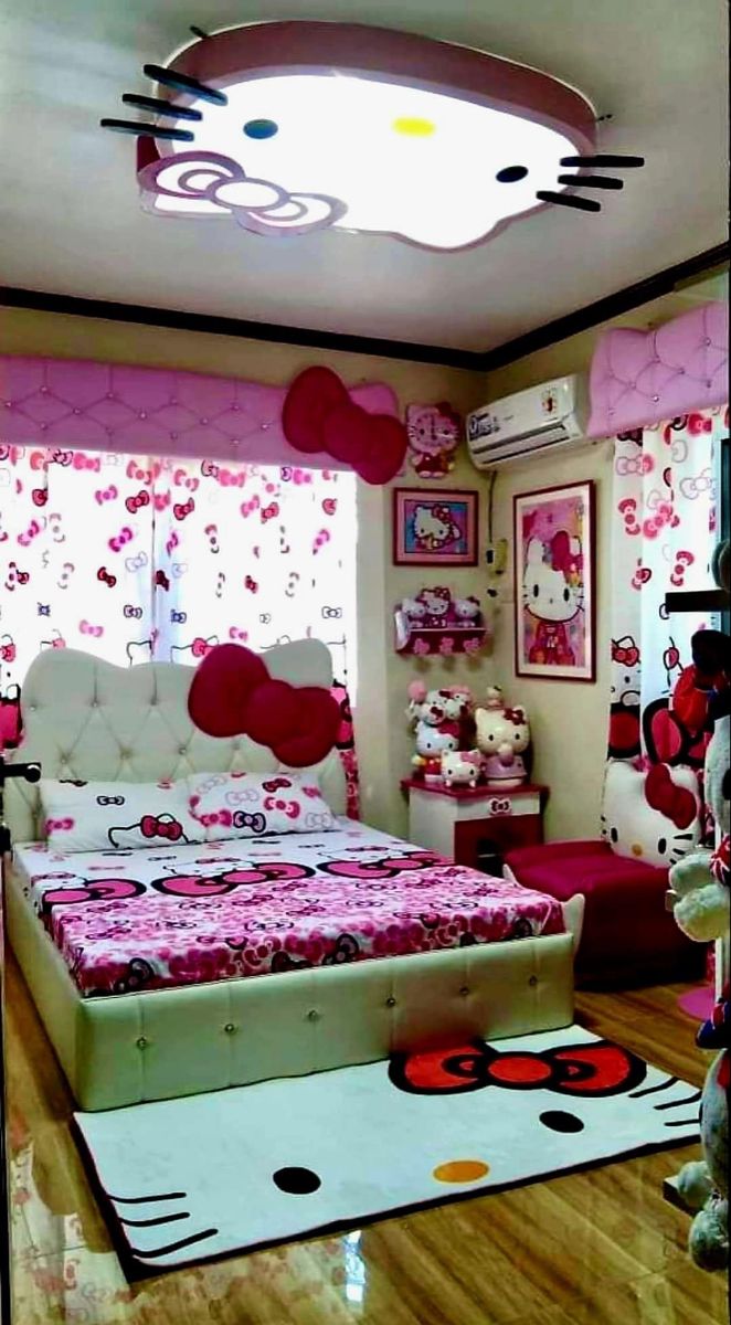 a bedroom with hello kitty decorations on the walls and ceiling, along with a bed