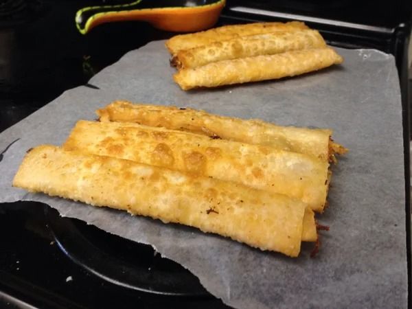 some food is sitting on top of a black tray in the oven and ready to be cooked