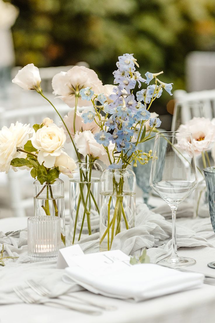 King Tables Wedding, Blue Pink White Wedding Theme, Blue Wild Flowers Wedding, Wedding Color Schemes With Teal, Light Blue Wildflower Wedding, Garden Party Wedding Blue, Bud Vase Flowers Wedding, White And Light Blue Flowers, Blue Flower Table Decorations