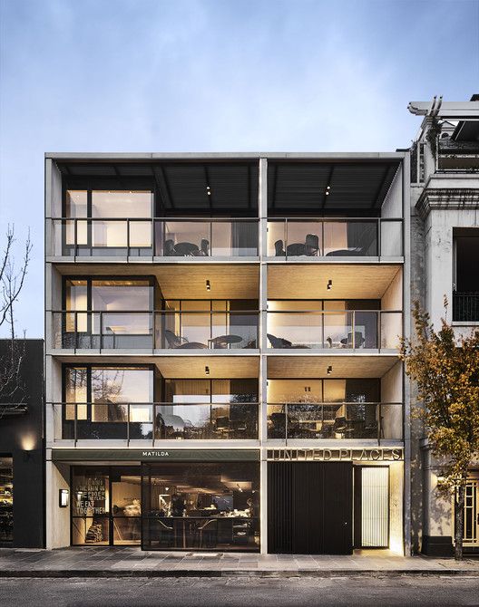 an apartment building with balconies on the second floor