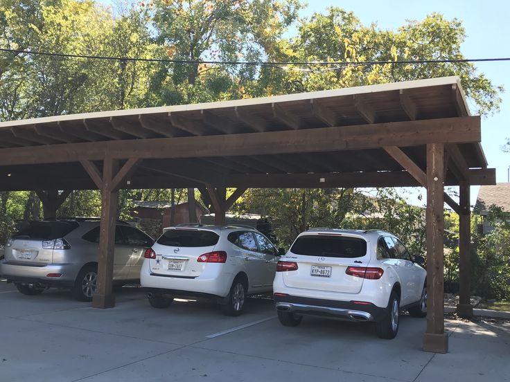 two cars parked under a covered parking lot