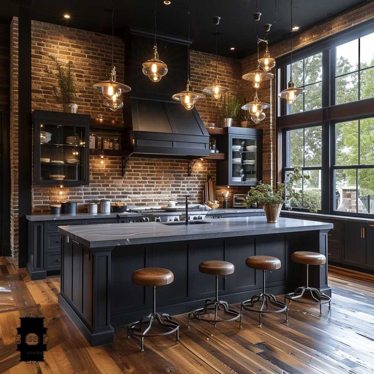 a large kitchen with wooden floors and black cabinets