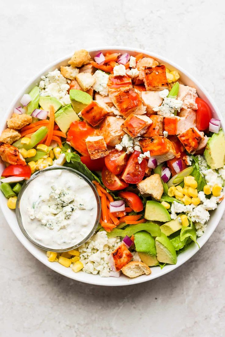 a white bowl filled with salad and dressing