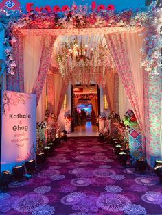 the entrance to a wedding venue decorated in pink and white