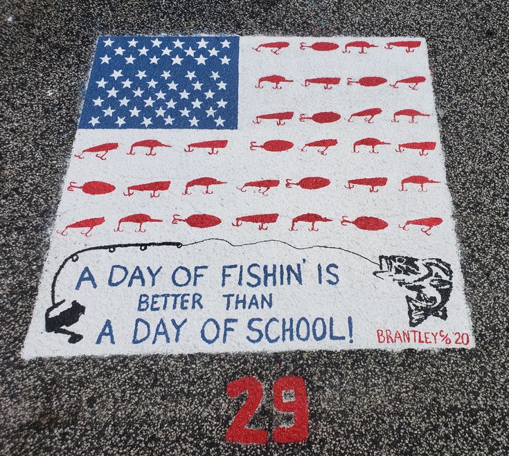 a sign on the ground that says, a day of fish is better than a day of school