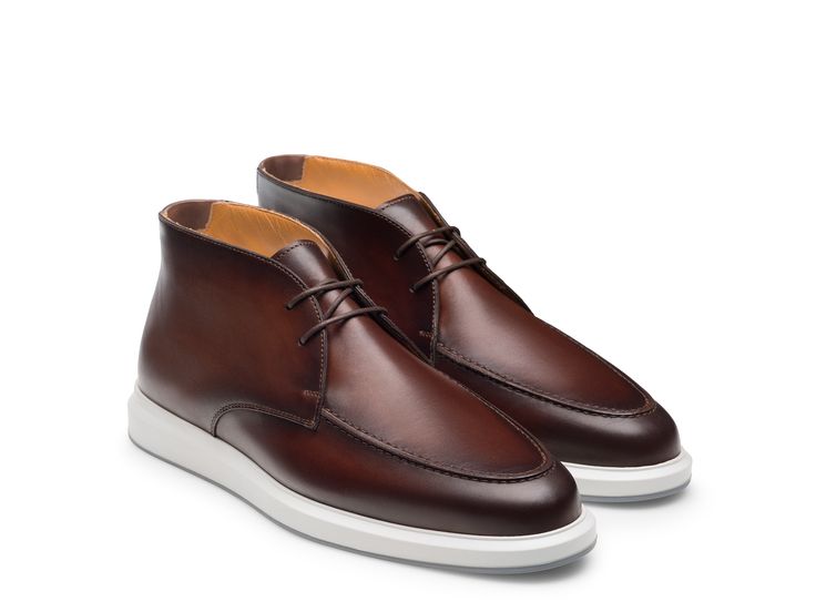 The Orion Chuk showcases Magnanni's take on a Chukka boot hybrid. This dapper boot features a traditional lace up design with a plain toe. The sleek dress silhouette is complemented with a comfortable footbed and cushioned sole, making it the ideal selection for an assortment of occasions. Modern Brown Boots With Stitched Sole, Formal Brown Desert Boots With Stitched Sole, Formal Fall Desert Boots With Rubber Sole, Classic Moc Toe Boots With Contrast Sole, Classic Boots With Moc Toe And Contrast Sole, Classic Lace-up Chelsea Boots For Formal Occasions, Casual Chelsea Boots For Formal Occasions, Goodyear Welted, Formal Chukka Boots With Textured Sole For Fall, Formal Boots With Contrast Sole And Plain Toe