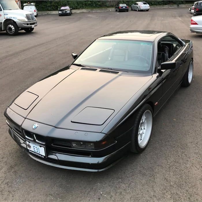 a black sports car parked in a parking lot