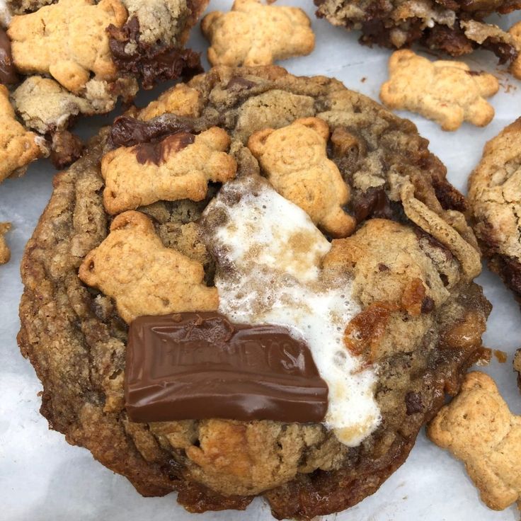 chocolate chip cookies and marshmallows are piled on top of each other