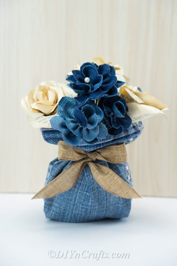 a blue vase filled with flowers on top of a table