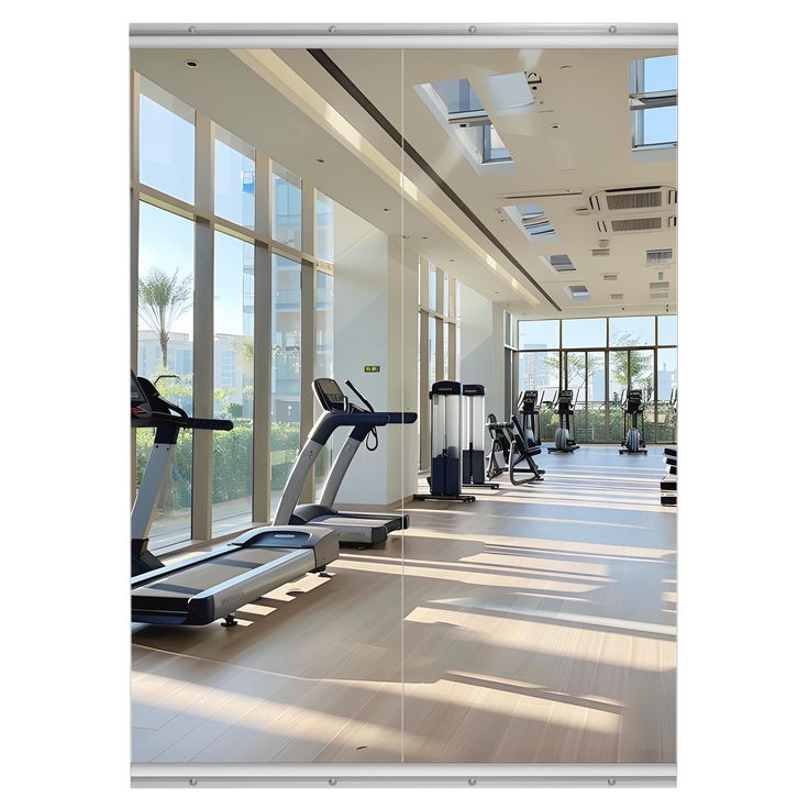 there are many treadmills in the gym with large windows on either side of them