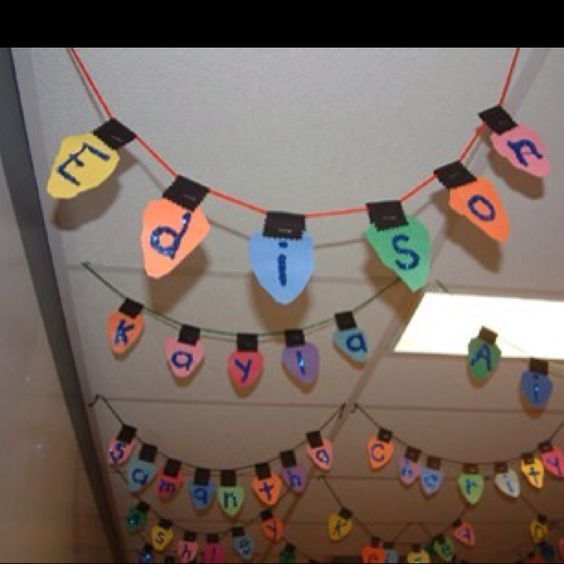 a birthday banner hanging from the ceiling with letters and numbers on it's strings