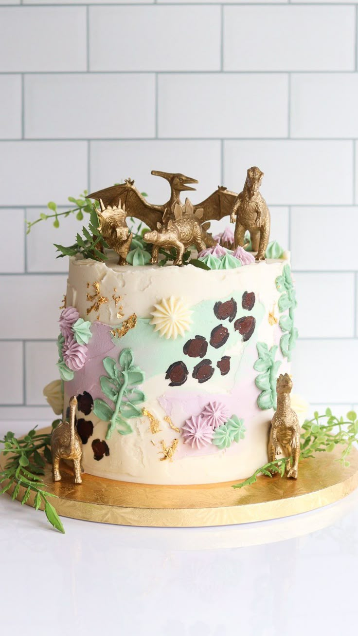 a cake decorated with animals and flowers on a wooden platter in front of a white brick wall