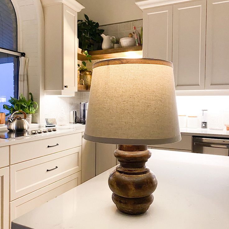 a table lamp sitting on top of a kitchen counter