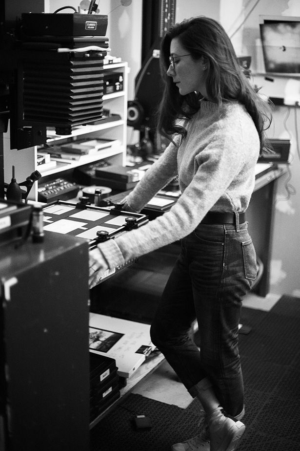 a woman standing in front of a computer desk