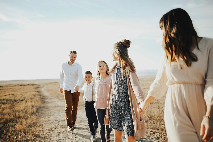 a family walking down a dirt road holding hands