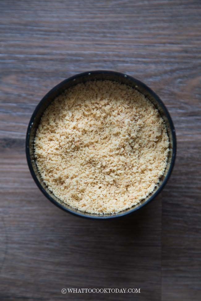 a bowl filled with rice on top of a wooden table