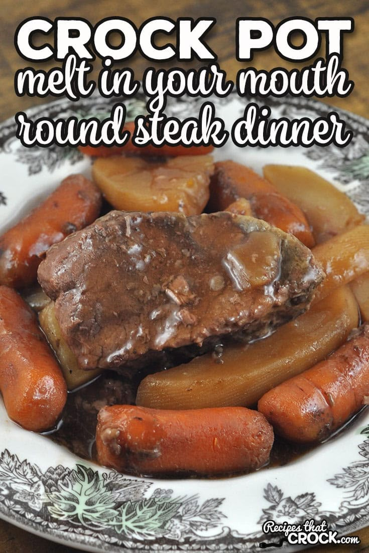 a white plate topped with meat and carrots on top of a wooden table next to a fork