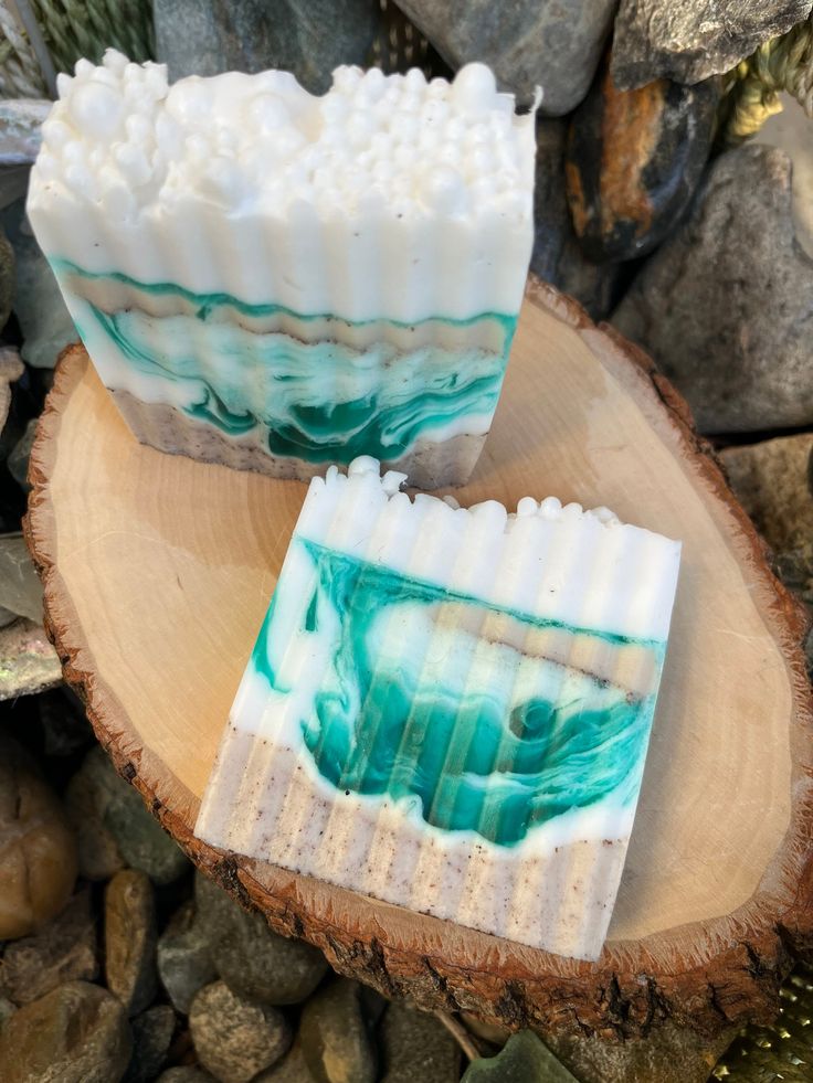 two soap bars sitting on top of a tree stump