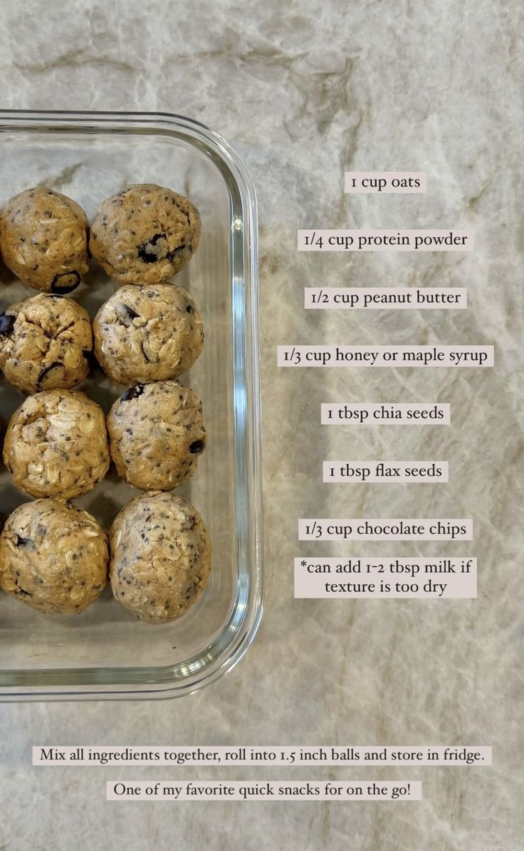 a glass container filled with oatmeal and chocolate chip cookie balls on top of a marble counter