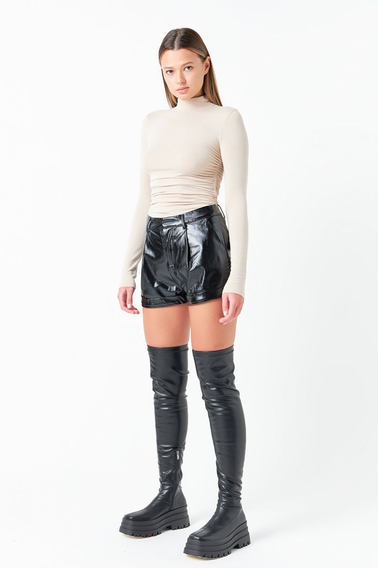 Shiny faux leather shorts with front pleating. Relaxed fit. Mid waist Shiny faux leather Belt loops Zip fly hook-and-bar closure Slash pockets Back decorative jet pockets Cuff Lined Hand wash cold Do not bleach Do not tumble dry Do not dry clean Do not iron Shell 1: 100% Polyester Shell 2: 100% Polyurethane Lining: 100% Polyester RS871P Total length: 12.6" Waist: 28" Inseam: 2.8" S BLACK: Height 5'7.5" / Bust 30" / Waist 24"/ Hip 35" Turtle Neck Leather Skirt, Chic Second-skin Turtleneck Bodysuit, Black Leather Knee-length Bottoms, Second-skin Turtleneck Bodysuit With Thumbholes, Turtle Neck Fits, Tight Full-length Faux Leather Bottoms, Jumpsuit Fall, Knit Bottom, Blazer And Shorts