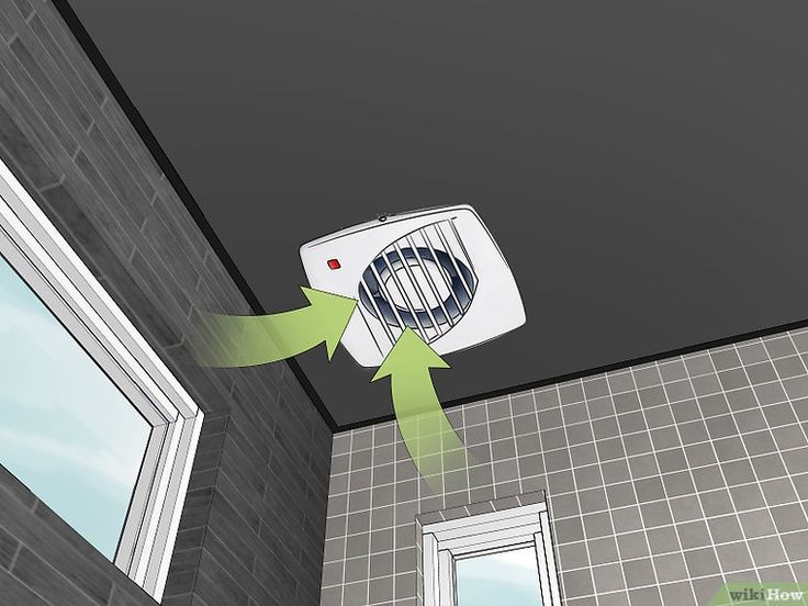 an air conditioner is hanging from the ceiling in front of a bathroom window with green arrows pointing to it