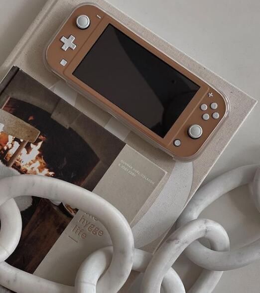 a nintendo wii game system sitting on top of a table next to some white cords