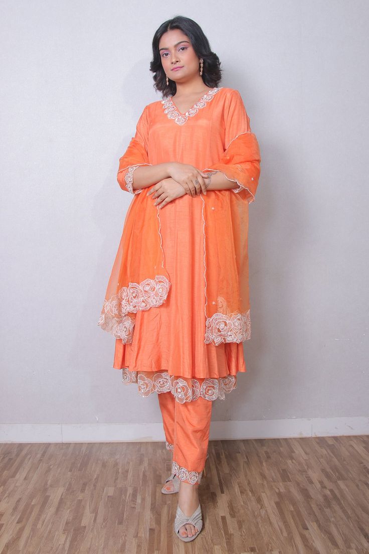 Rust orange silk organza anarkali with resham, sequins and cutdana embroidered neckline, cuffs and double layered hem. Comes with straight pant and a dupatta.
Components: 3
Pattern: Embroidered
Type Of Work: Resham, Sequins, Cutdana
Neckline: V Neck
Sleeve Type: Three quarter
Fabric: Silk organza
Color: Orange
Other Details: 
Embroidered borders on dupatta
Attached lining
Occasion: Mehendi and Haldi - Aza Fashions Organza Anarkali, V Neck Anarkali, Embroidered Anarkali, Embroidered Neckline, Rust Orange, Silk Organza, Fashion App, Fabric Silk, Pant Set