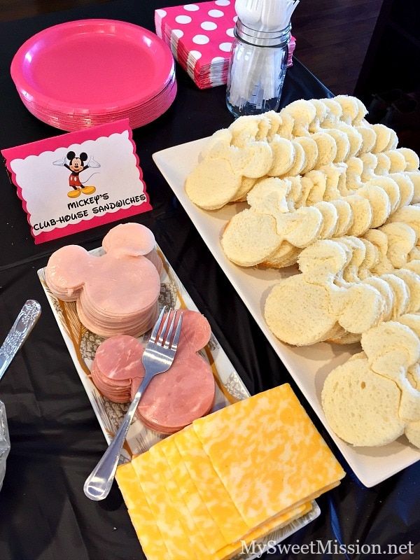 a table topped with lots of different types of food next to plates and utensils