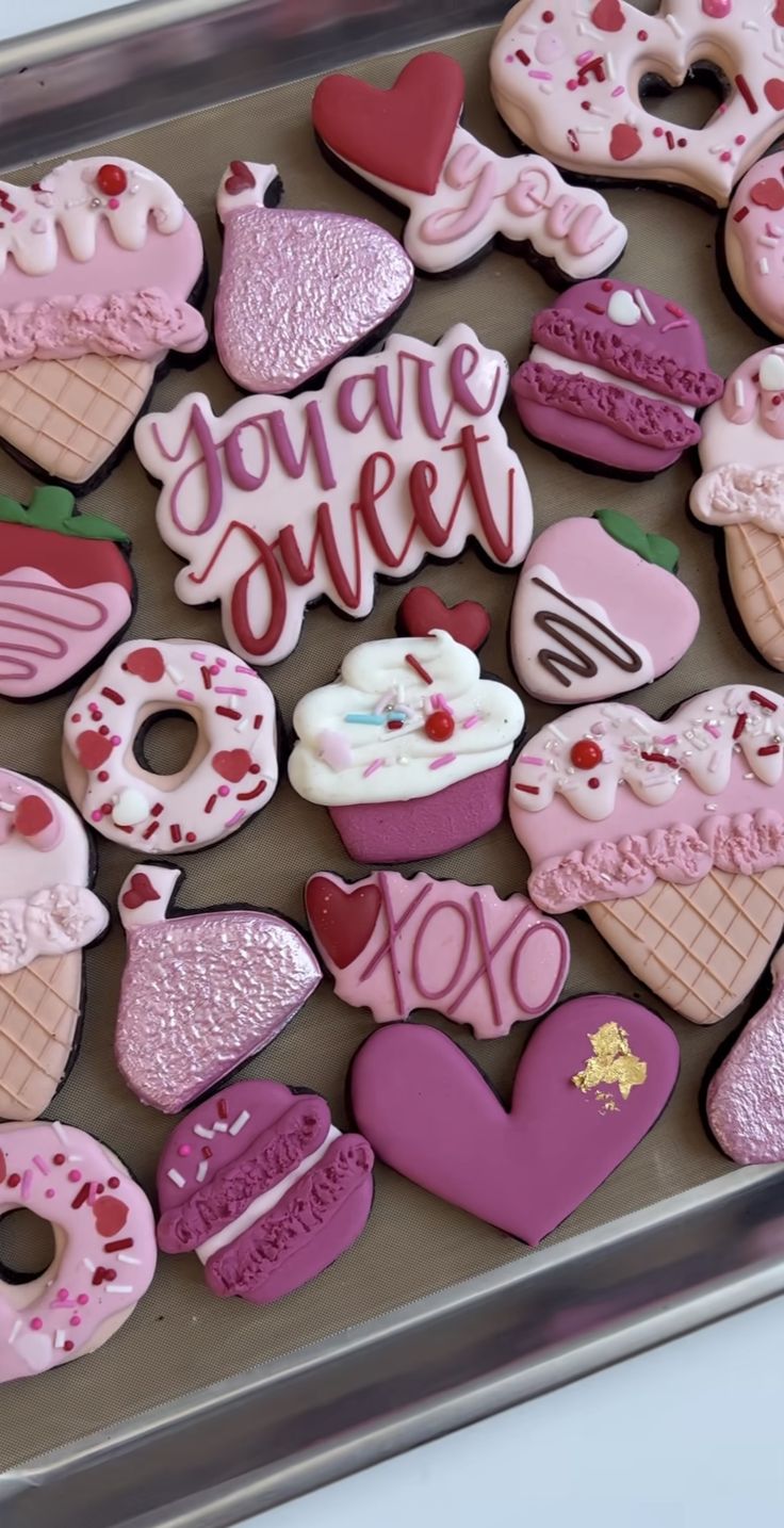 decorated cookies in the shape of hearts and ice creams on a cookie sheet that says, you're sweet