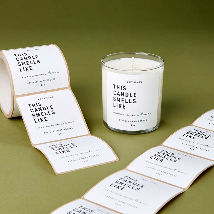 candles and labels on a table with a candle in the middle next to each other