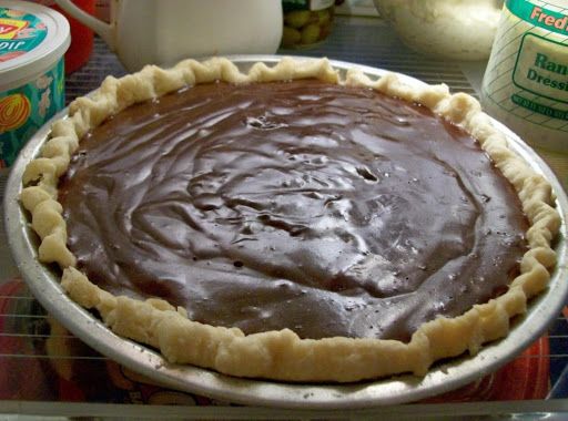 a chocolate pie sitting on top of a metal pan