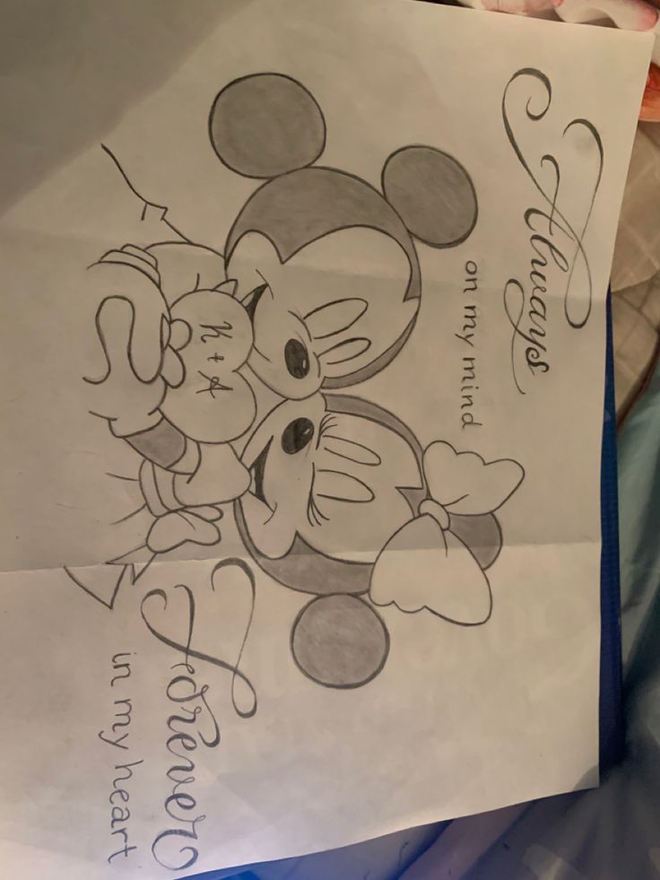 a paper bag with a drawing of mickey and minnie mouse on it's side