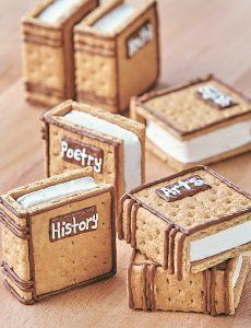 four small books made out of crackers sitting on a wooden table next to each other