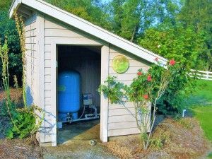 a small shed with a blue water tank in it