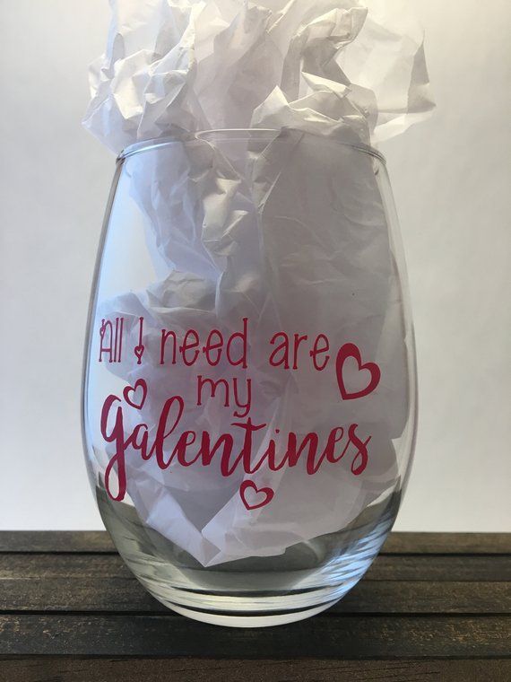 a wine glass with tissue paper in it that says all i need are my valentines