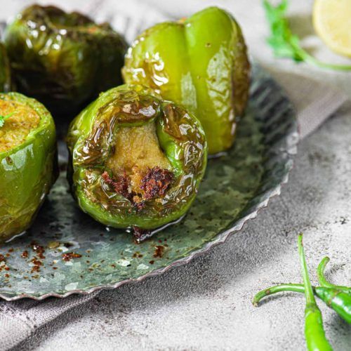 some green peppers are on a plate with seasoning