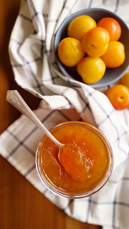 a bowl of oranges sitting next to a bowl of fruit