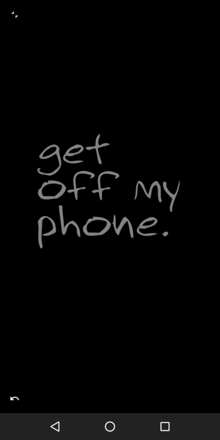 the text get off my phone is written in white chalk on a black background,