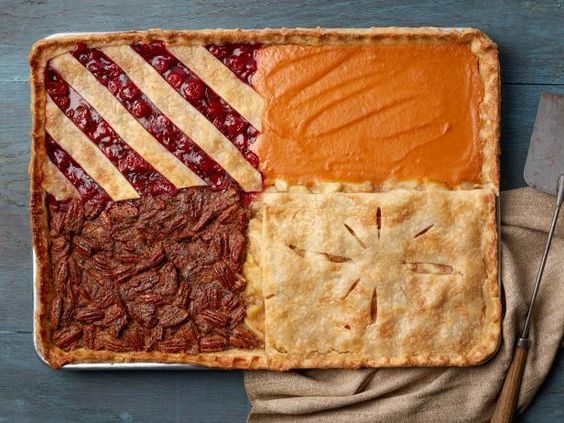 a pie with several different types of toppings on it and a fork next to it