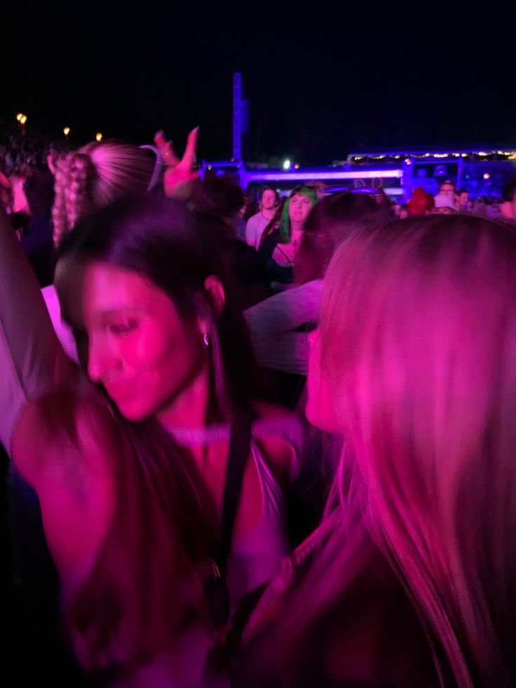 a group of people standing around each other at a concert