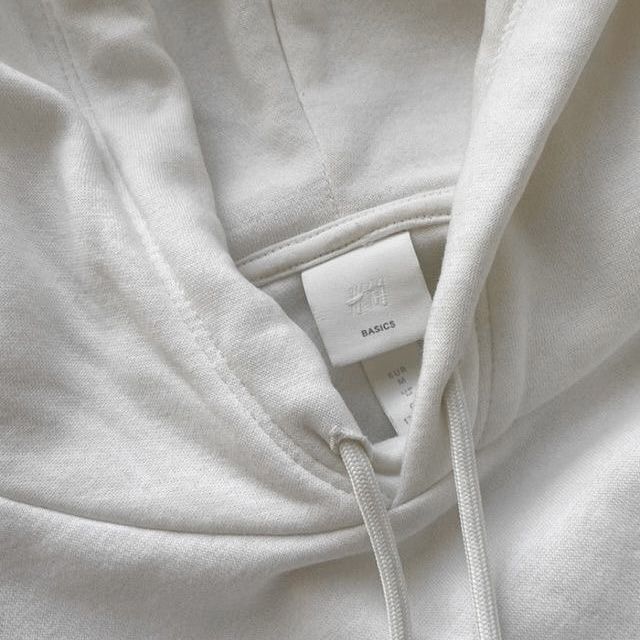 a white hoodie with a tag on it