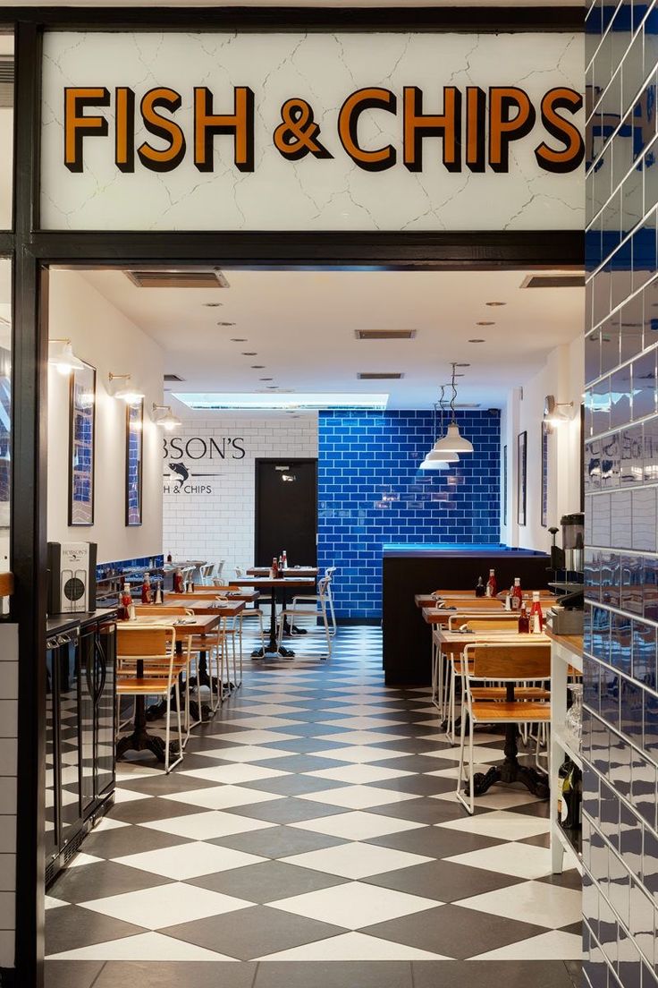 a fish and chips restaurant with checkered flooring in the front entrance to it