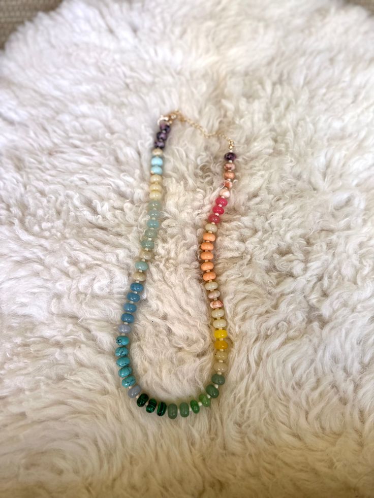 This rainbow inspired necklace is all about fun vibes, with a gradient of colors that flow from cool blues and greens to warm oranges, yellows, and soft pastels. Each semi-precious stone is strung together to create a unique, cheerful piece to add to your collection! This necklace is perfect for anyone looking to add a pop of color and a bit of playful charm to their everyday style! Features • Semi Precious Gemstones • Glass Seed Beads • Gold plated brass clasp and extender • Measures 16” plus a Colorful Beaded Adjustable Necklaces, Rainbow Natural Stones Round Beads Necklaces, Colorful Adjustable Necklaces With Round Beads, Rainbow Beaded Necklaces With Natural Stones, Multicolor Beaded Necklaces With Natural Stones For Jewelry Making, Colorful Necklaces With Round Natural Stones, Adjustable Rainbow Necklace With Colorful Beads, Rainbow Gemstone Beaded Necklaces For Healing, Rainbow Gemstone Beaded Necklaces As A Gift