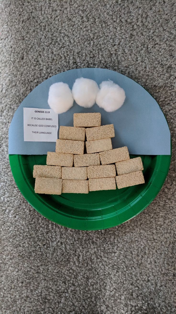 a green plate topped with lots of food on top of a gray carpeted floor