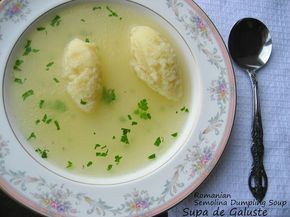 a bowl of soup with two dumplings in it